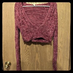Maroon half length sweater with a hood in the back